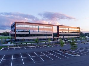 The GLVREA office building exterior in the evening sunset with the large parking lot